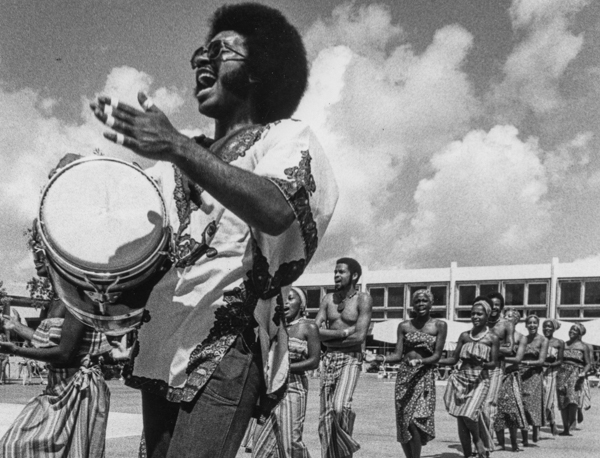Student leading march with drum Student leading march with drum