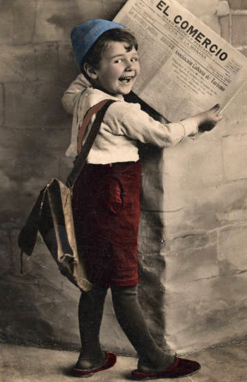 Little boy holding a newspaper